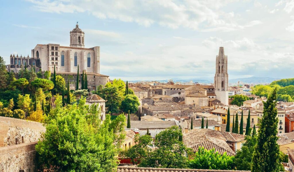 The colorful old buildings of Girona, Spain with a towering cathedral overlooking the Old Town
