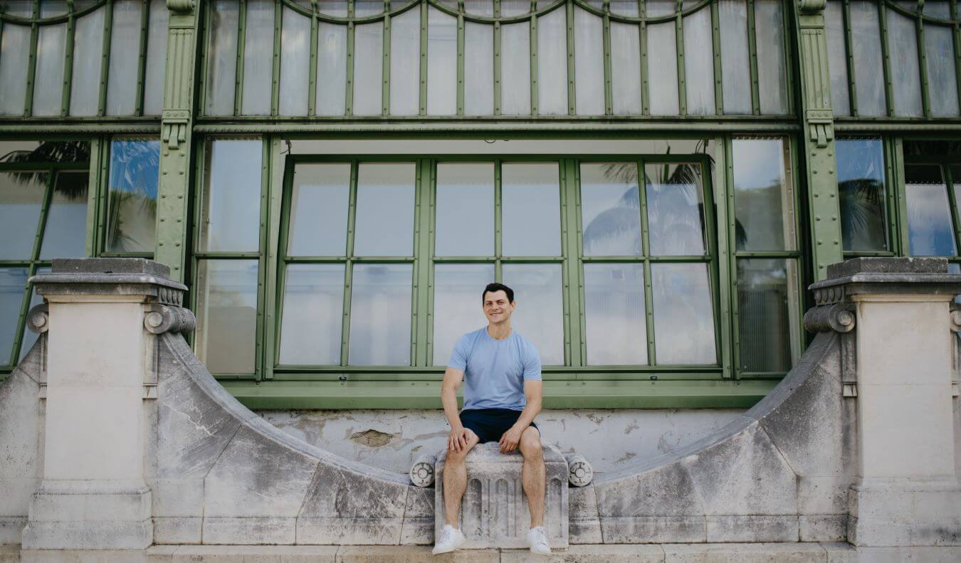 Nomadic Matt sitting on a bridge in Vienna, Austria